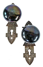 several matching sets of original 1880's salvaged chicago "jet black" niles patented screwless spindle doorknobs and matching ornamental cast iron backplates