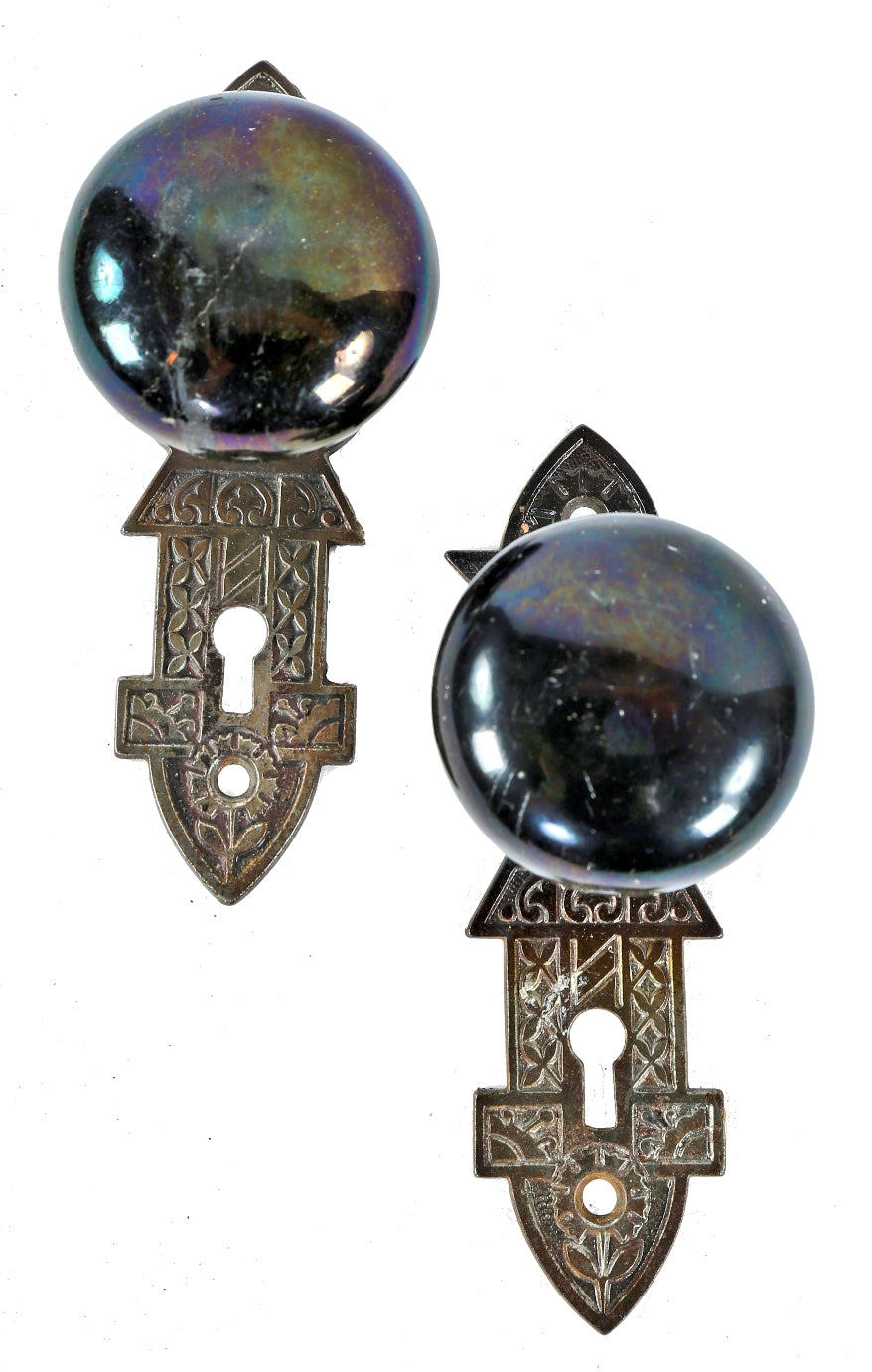 several matching sets of original 1880's salvaged chicago "jet black" niles patented screwless spindle doorknobs and matching ornamental cast iron backplates