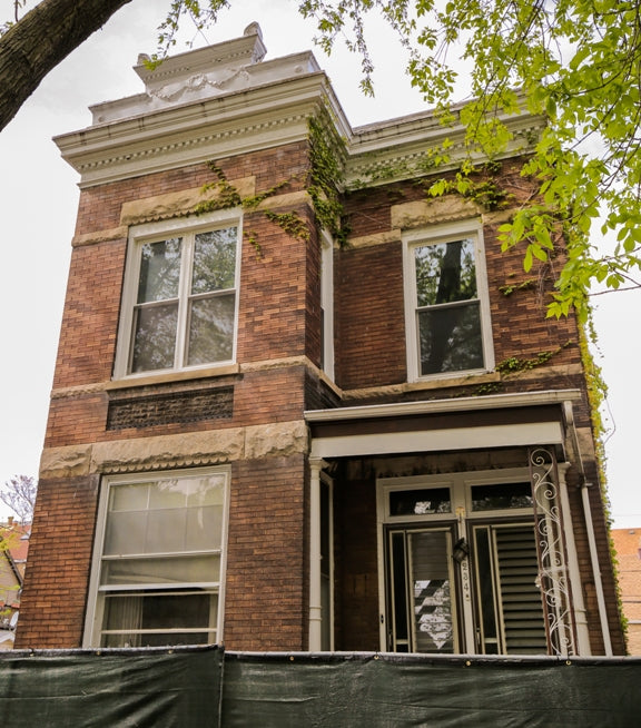 late 19th or early 20th century original and intact varnished oak wood interior residential chicago two-flat staircase newel post with railing and spindles