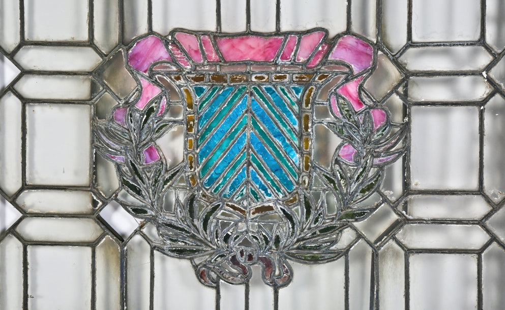 unusual c. 1910-195 salvaged chicago oversized leaded art glass residential window featuring a centrally located variegated shield and laurel wreath