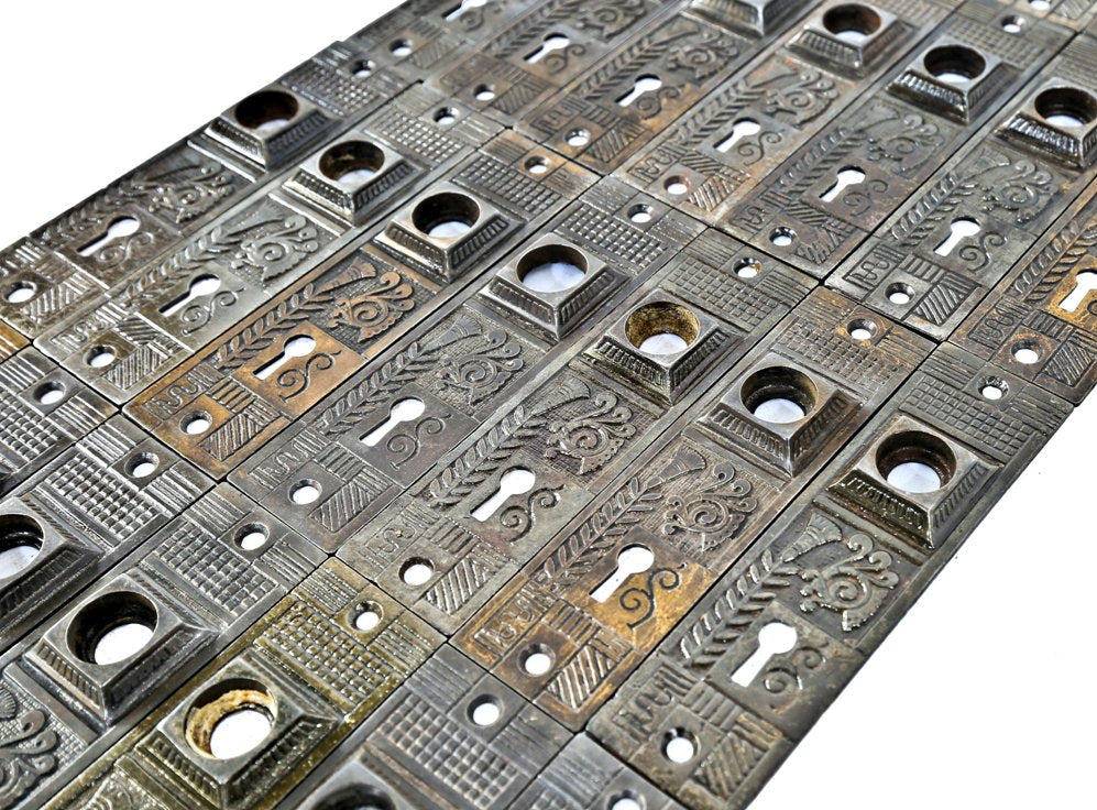 large lot of all original ornamental cast iron c. 1880's refinished salvaged chicago residential passage door backplates or escutcheons with a mostly uniform surface patina