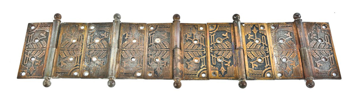 matching early 20th century ornamental cast iron interior residential door hinges with partially intact brass plated finish and ball finials