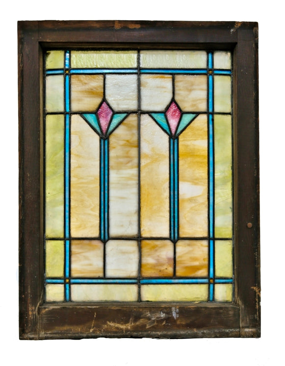 original and intact c. 1920's salvaged chicago variegated art glass bungalow window with two matching centrally located abstract floral motifs enclosed in the original wood sash frame