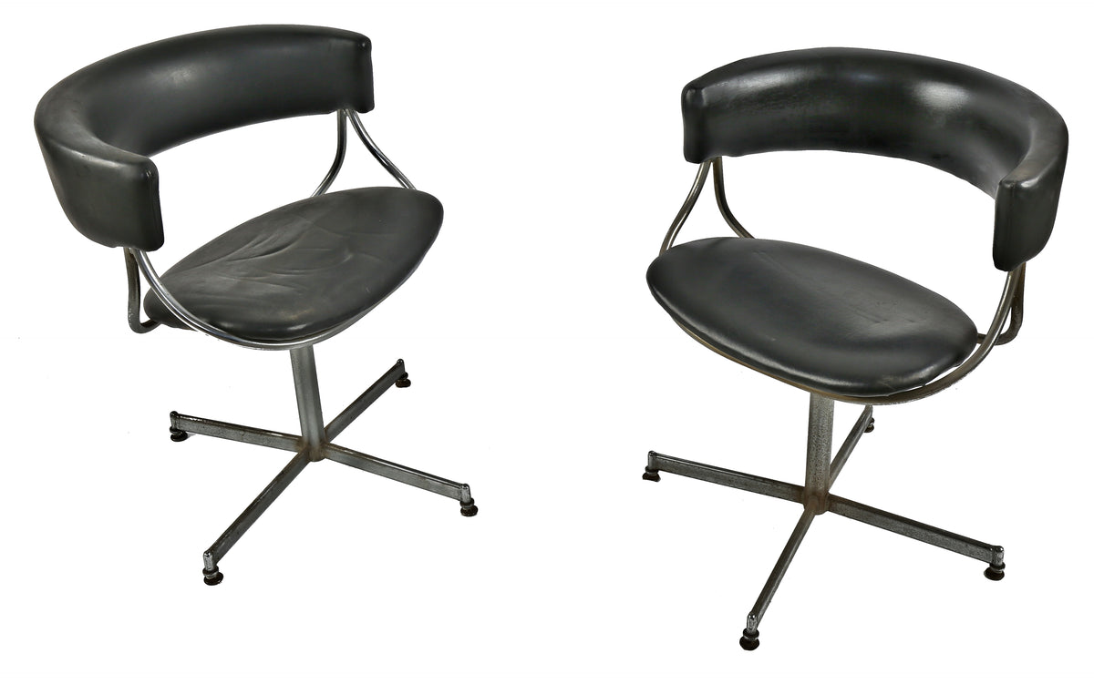 pair of jansko stationary mid-century modern interior residential swivel chairs upholstered in soft black faux leather with interesting backrest detail and original rubberized protective feet