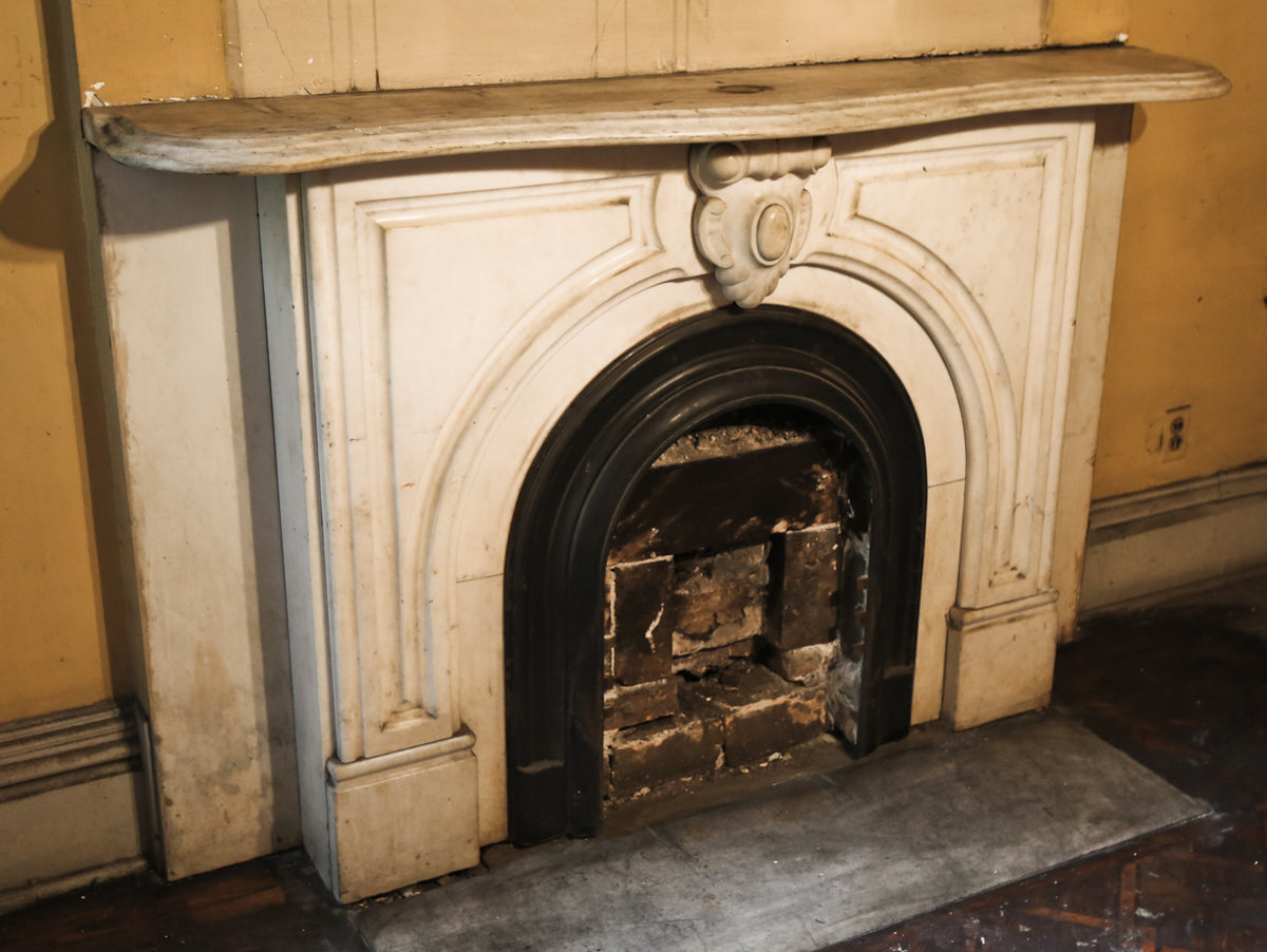 original early 1870's salvaged chicago interior residential white carrara marble fireplace mantel with arch top opening and ornamental keystone