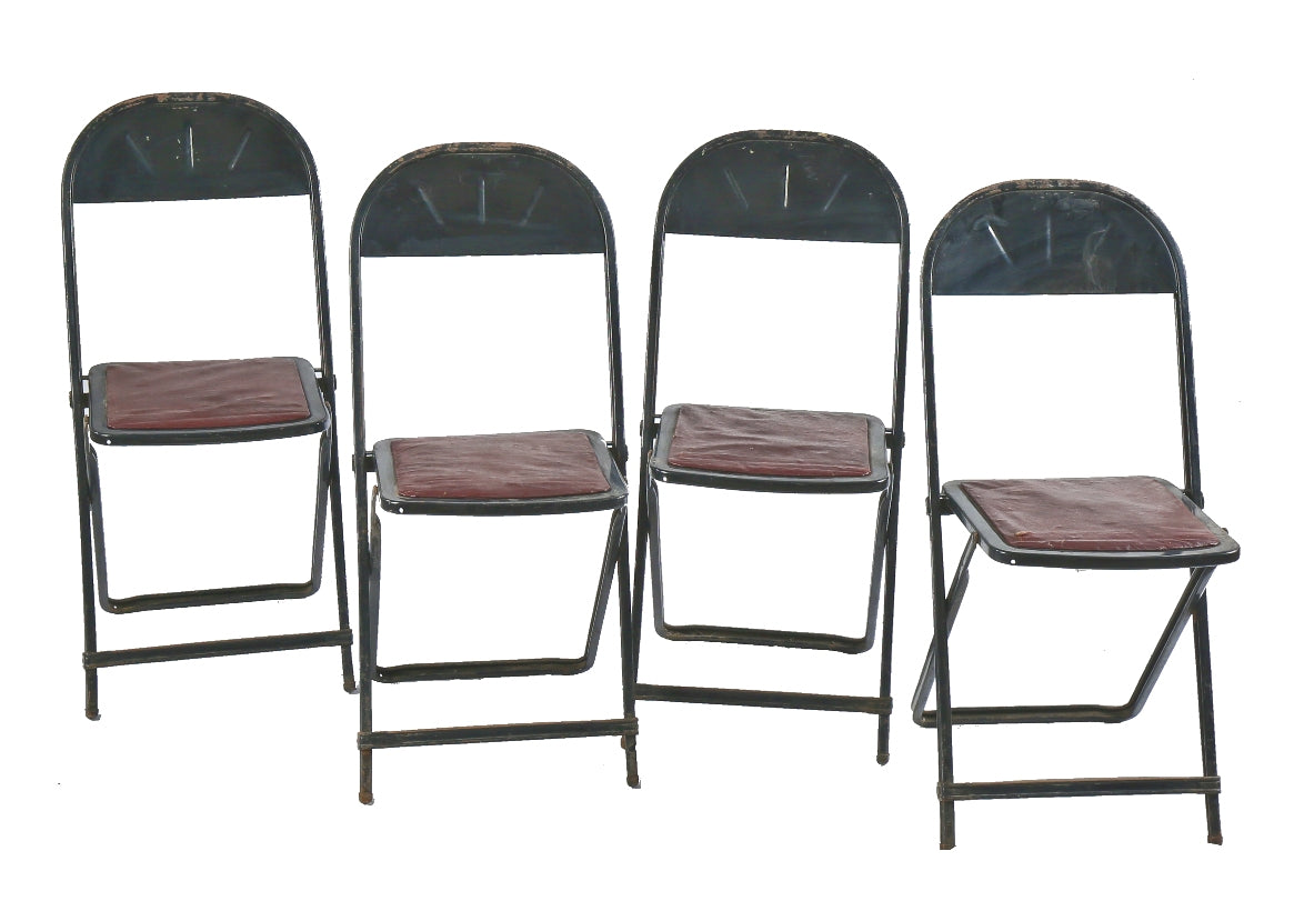 group of four matching heavily reinforced pressed and folded black enameled chicago stadium industrial folding chairs with original seat pads