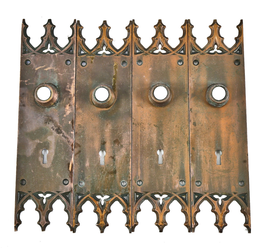 group of four matching salvaged chicago cast bronze gothic style interior church door escutcheons or backplates with nicely aged surface patina