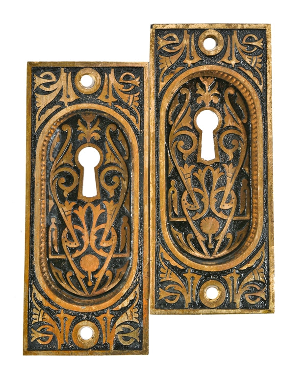 matching set of original c. 1880's ornamental cast bronze interior residential eastlake style pocket or sliding door escutcheons with largely intact baked black enameled inlay