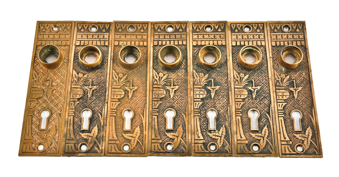 group of matching ornamental cast brass "broken leaf" pattern c. 1880's eastlake style interior residential doorknob backplates with nicely aged surface patina