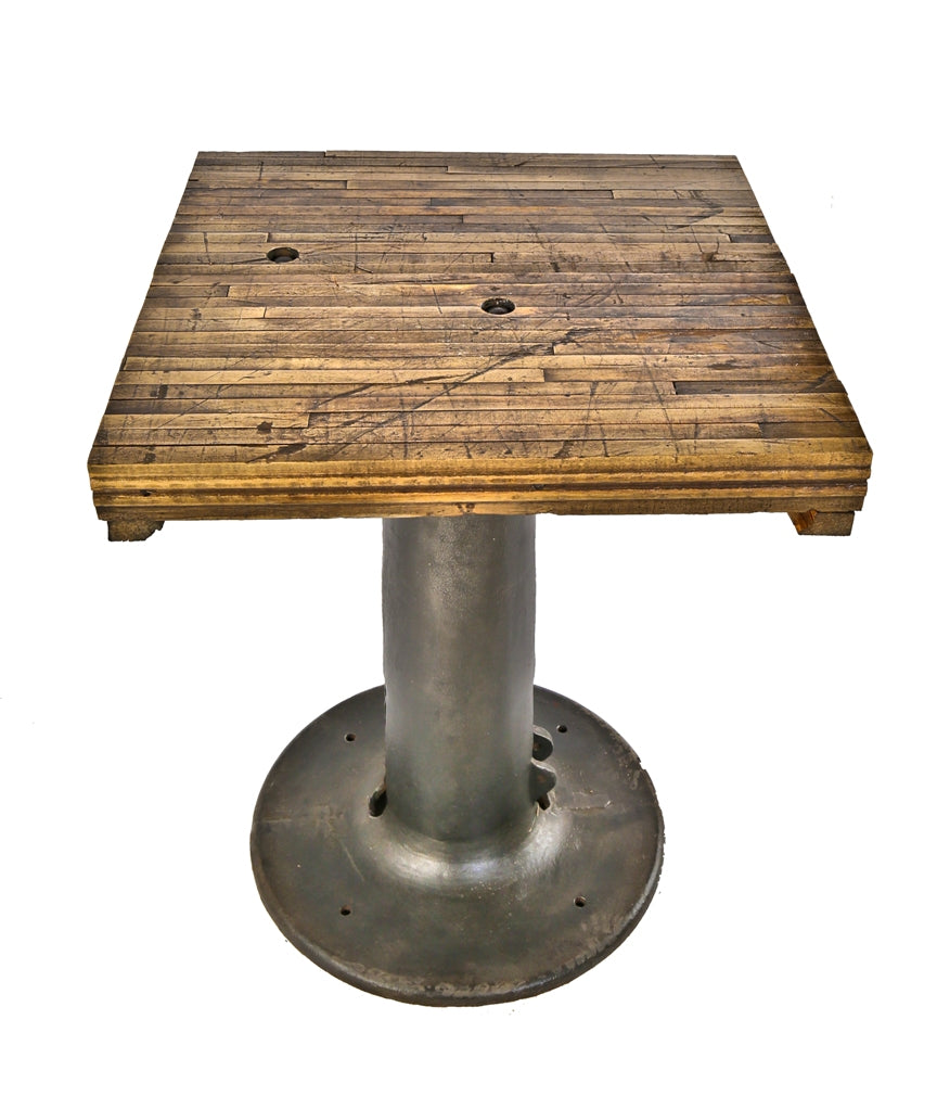 single heavy duty freestanding salvaged chicago factory machine shop multi-purpose table with tapered cast iron grinder base brushed down to bare metal