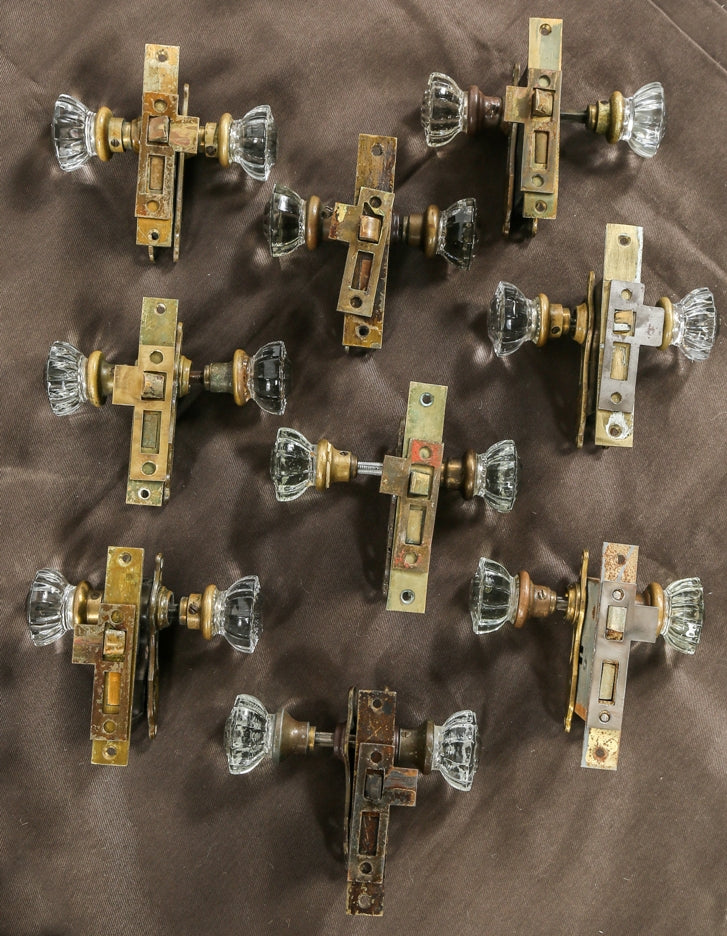 nine matching sets of early 20th century original and intact interior residential salvaged chicago pressed glass doorknob locksets with strike plates