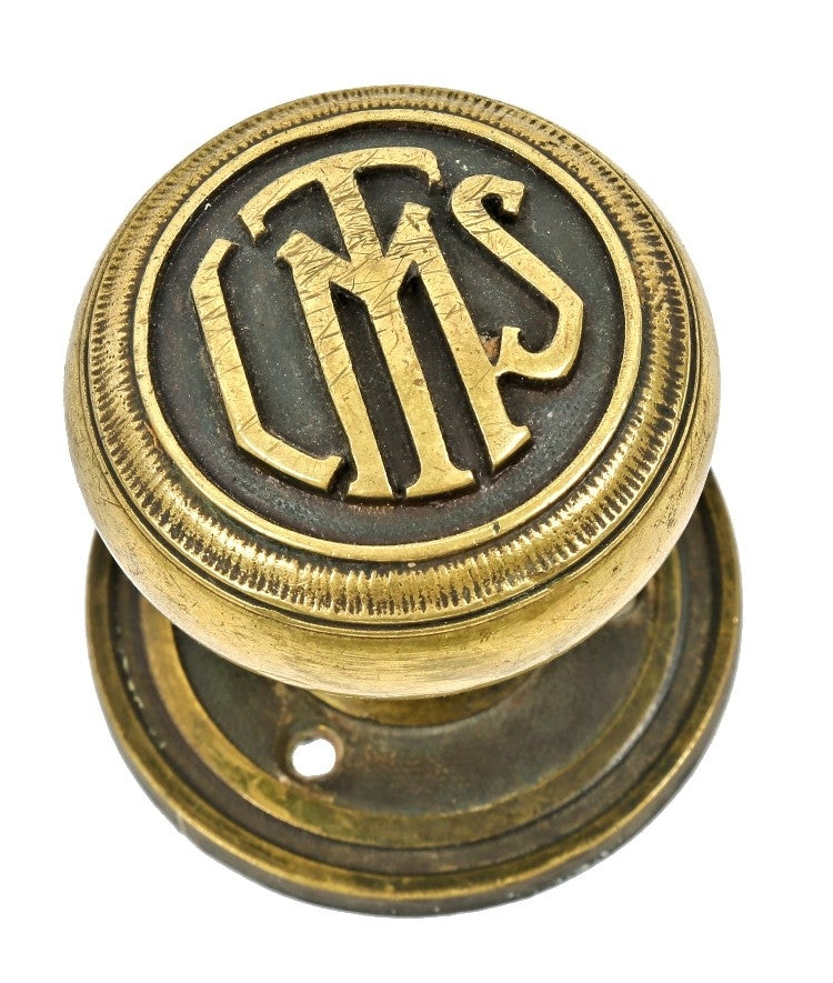 group of four matching interior logan square masonic temple building monogrammed cast brass doorknobs with nicely aged surface patina