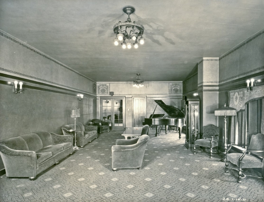 one of several original early 20th century logan square interior hanging wrought iron lights with barebulb cluster sockets