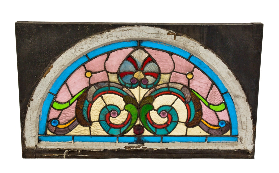 1880's richly colored arch top victorian era salvaged chicago residential stained glass lunette window with several jewels and textured cathedral glass