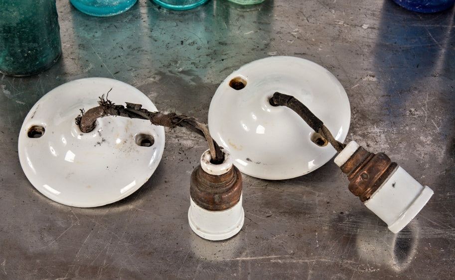 pair of original c. 1918 reinforced white ceramic bare bulb chicago factory pendant light fixtures with intact cloth cord wiring and canopies