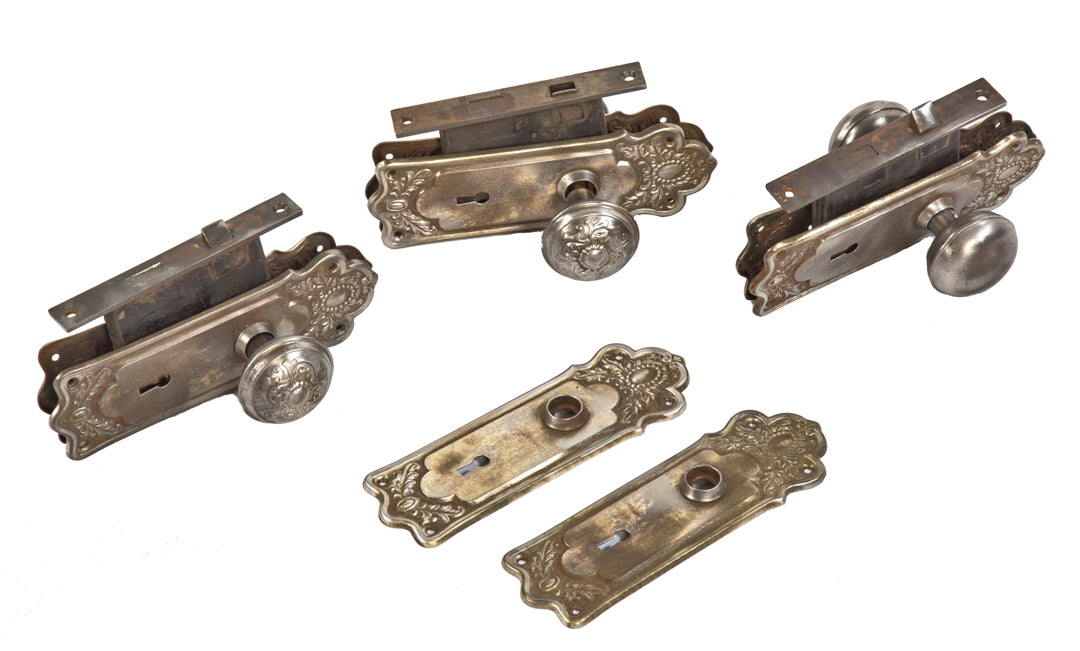 three sets of original pressed steel early 20th century antique american salvaged chicago passage door locksets with fanciful knobs and backplates