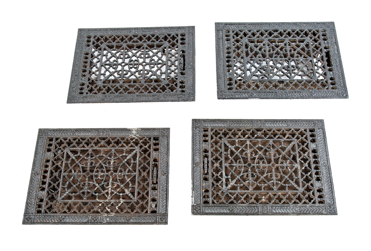 group of four matching intricately designed ornamental cast iron 19th century salvaged chicago louvered floor grates or registers with black enameled finish