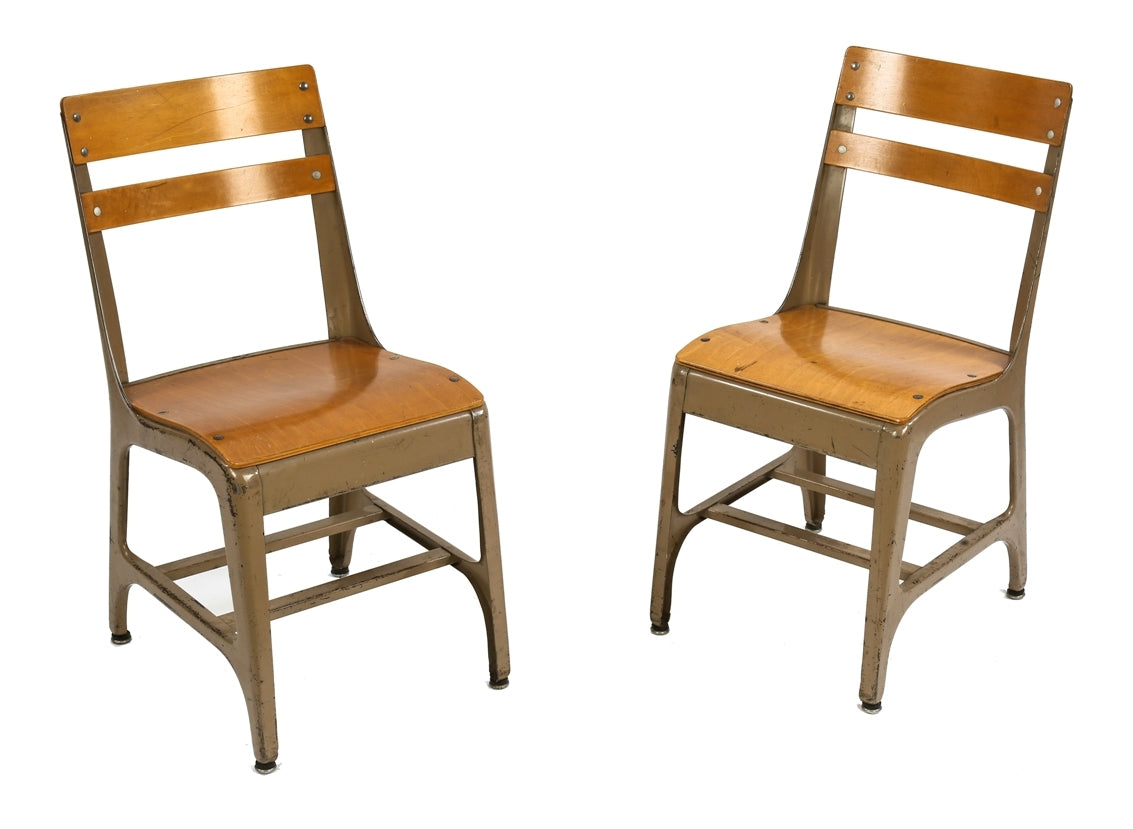 two matching vintage american industrial four-legged low-lying salvaged chicago public school wood and metal chairs with maple seats and backrests