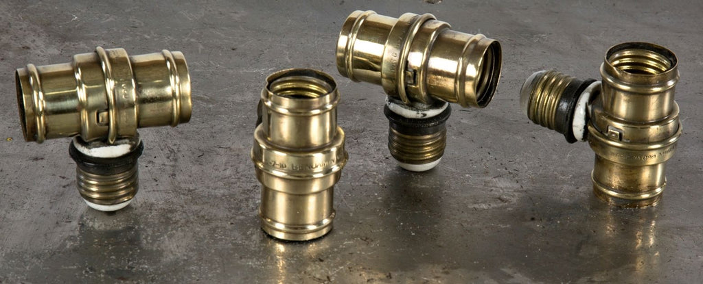 one of four matching fully functional c. 1910 patented brass shell benjamin rotating dual socket extensions for use with two incandescent light bulbs