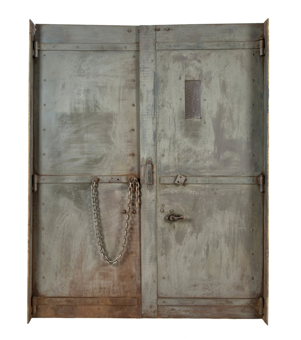 two interlocking early 20th century heavy gauge steel salvaged chicago factory building freestanding elevator doors with diminutive portal containing chicken wire glass