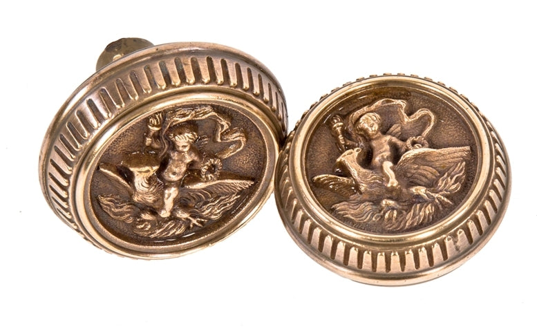 set of original late 19th century antique american ornamental cast brass "cherub" residential entrance door handles featuring cherub grasping torch with flame finial