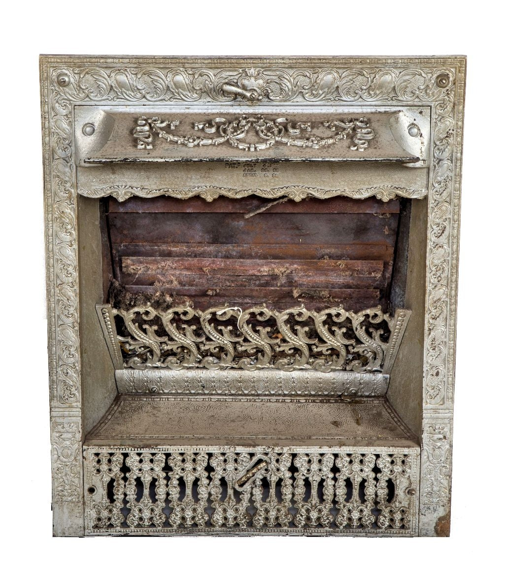single 19th century original and intact ornamental cast iron interior residential gas fireplace insert with protruding hood and perforated grill