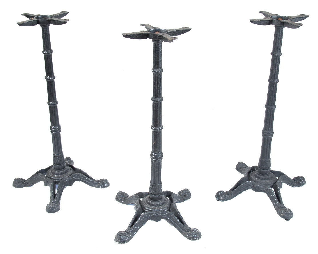 one of three matching intact salvaged chicago ornamental cast iron black enameled four-legged bar or pub table bases