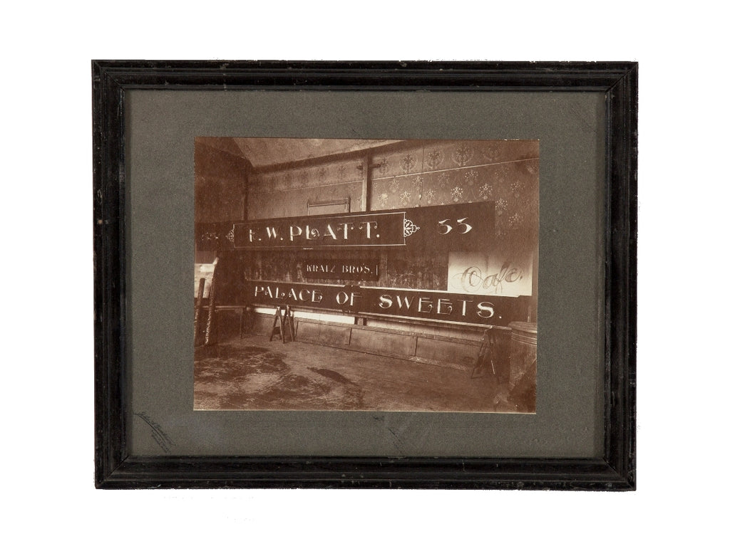 rare original and intact late 19th or early 20th century sepia-toned gelatin silver print of a building sign shop studio interior located in or around winona, minnesota