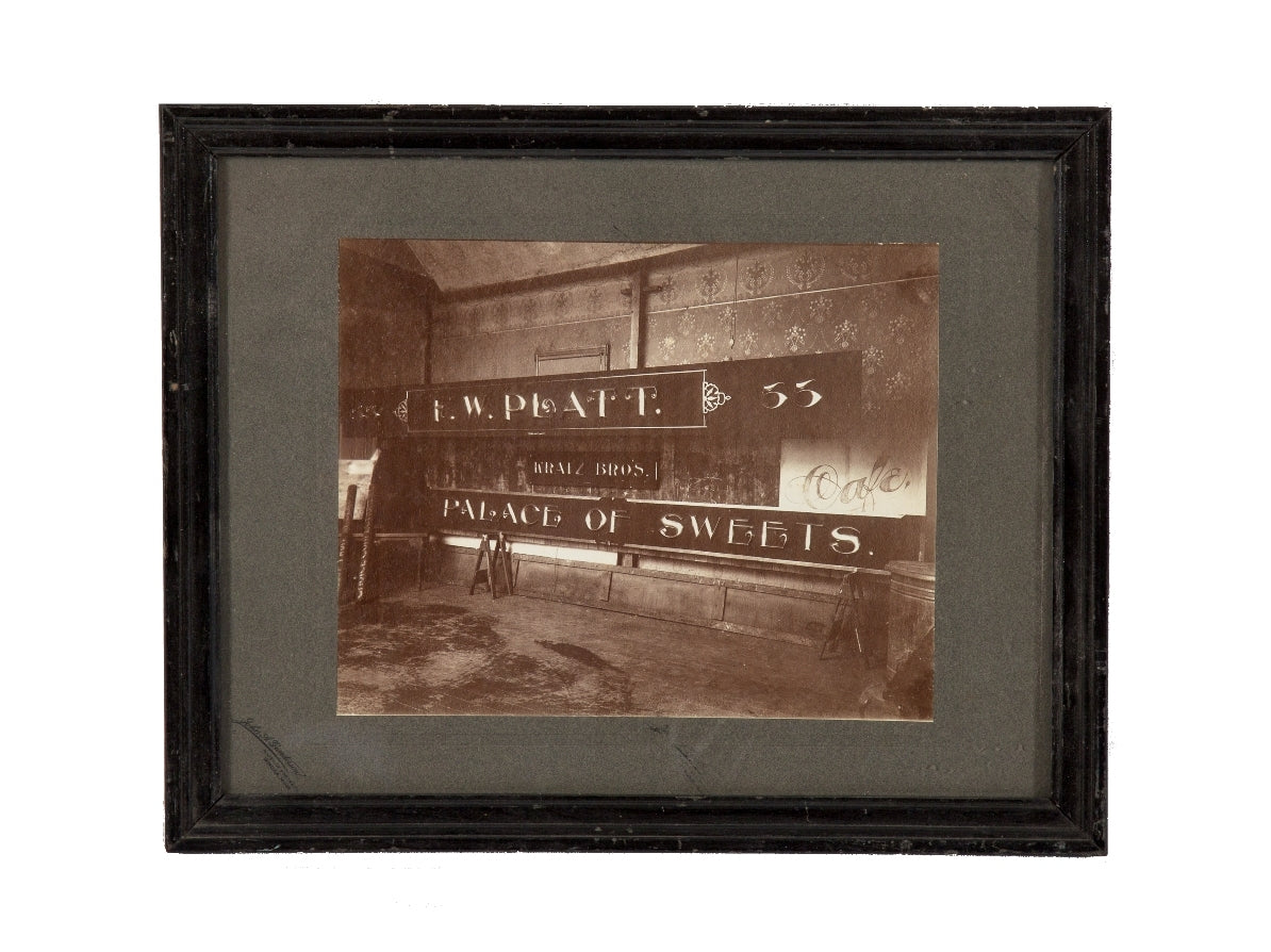 rare original and intact late 19th or early 20th century sepia-toned gelatin silver print of a building sign shop studio interior located in or around winona, minnesota