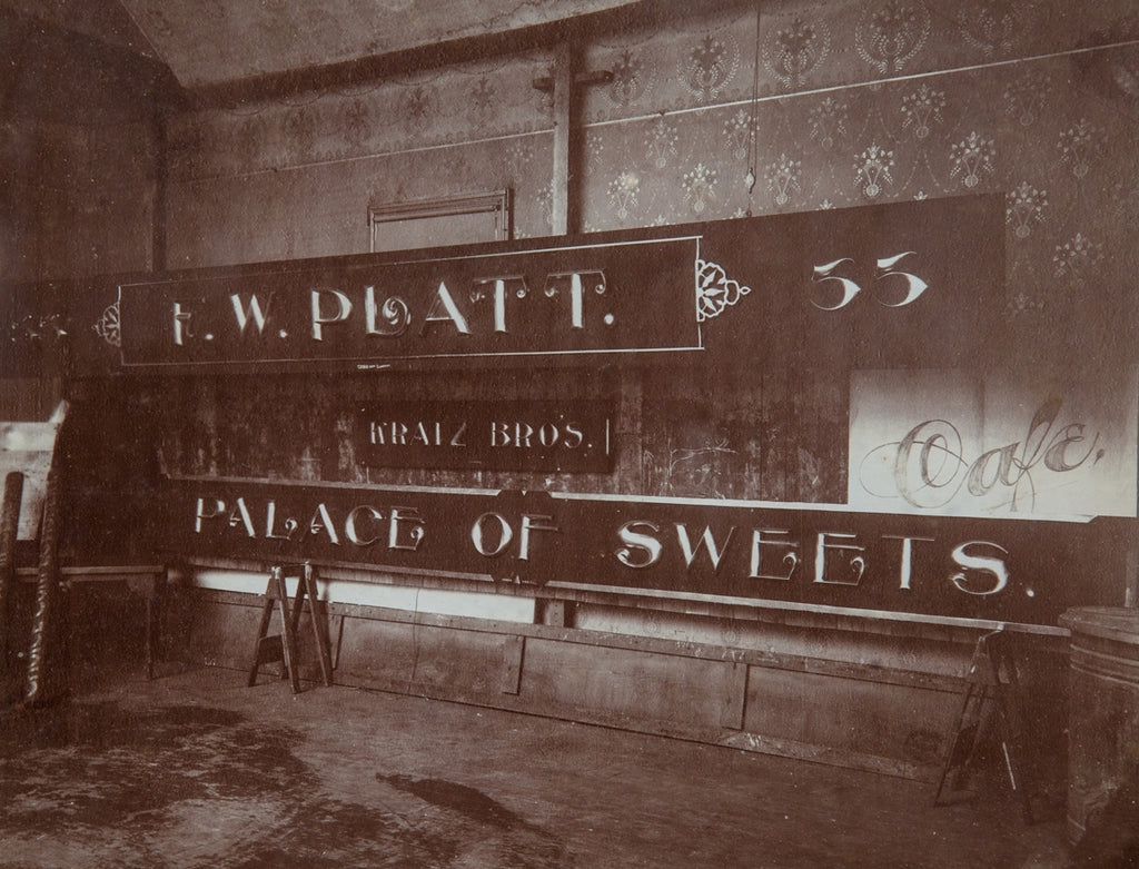 rare original and intact late 19th or early 20th century sepia-toned gelatin silver print of a building sign shop studio interior located in or around winona, minnesota