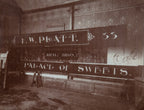 rare original and intact late 19th or early 20th century sepia-toned gelatin silver print of a building sign shop studio interior located in or around winona, minnesota