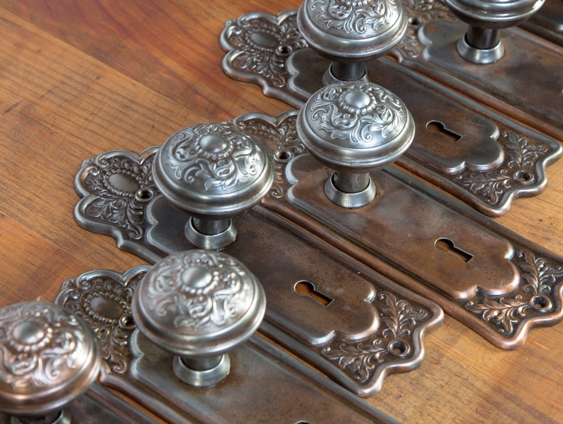 large lot of original early 20th century pressed or stamped ornamental copper-plated steel interior residential salvaged chicago matching backplates and doorknobs