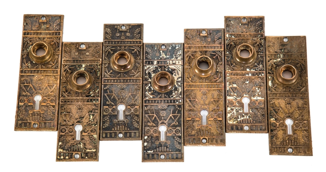 lot of original c. 1880's eastlake style "windsor" pattern interior residential cast brass passage door escutcheons with single keyholes and intricate floral motifs
