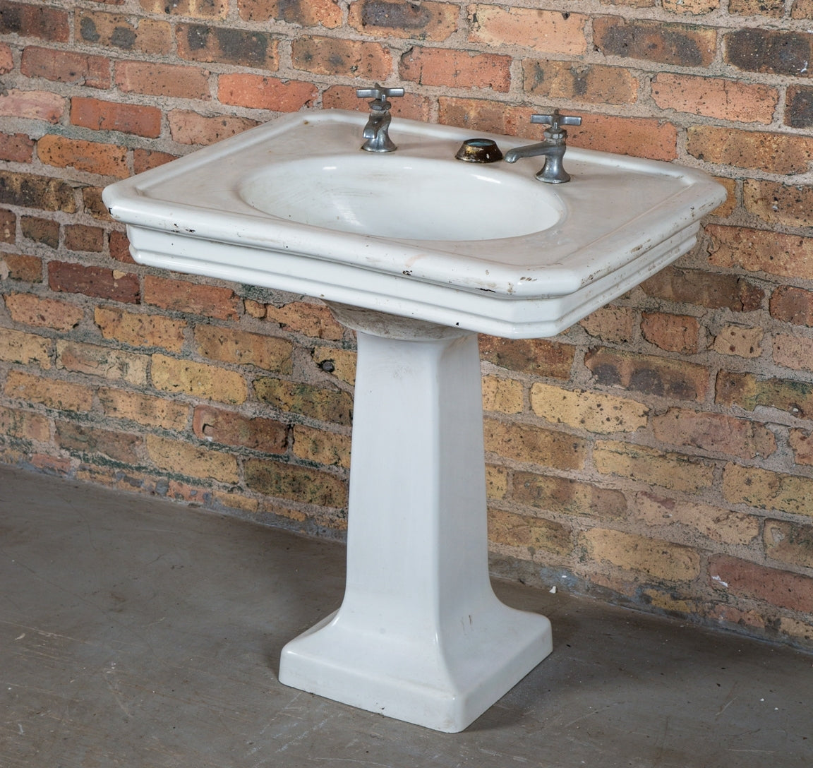 original early 20th century antique american salvaged chicago white glazed vitreous porcelain residential pedestal sink with stepped apron and original cross-arm faucets