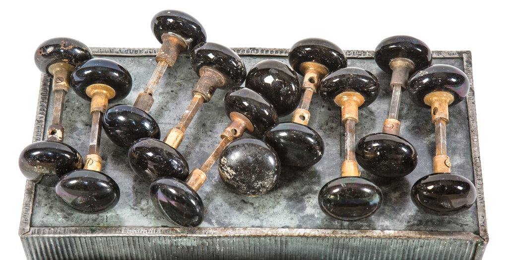 ten matching set of late 19th century original and intact "jet black" glazed ceramic interior residential doorknobs with nicely aged cast brass shanks