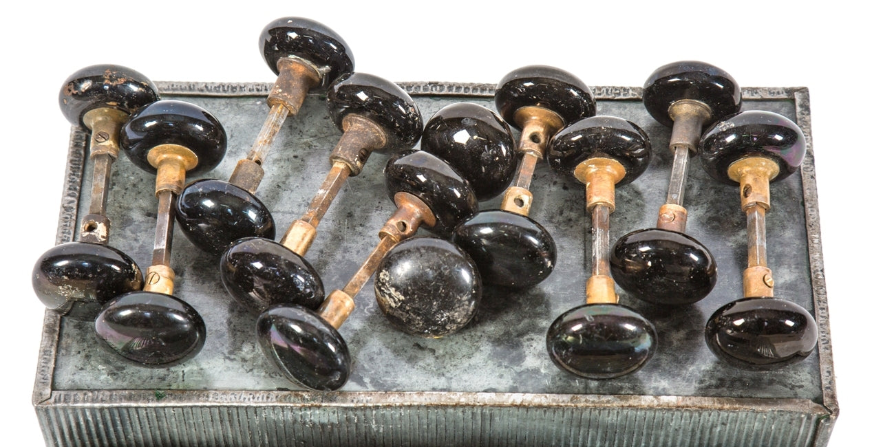 ten matching set of late 19th century original and intact "jet black" glazed ceramic interior residential doorknobs with nicely aged cast brass shanks