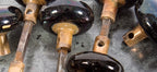 ten matching set of late 19th century original and intact "jet black" glazed ceramic interior residential doorknobs with nicely aged cast brass shanks