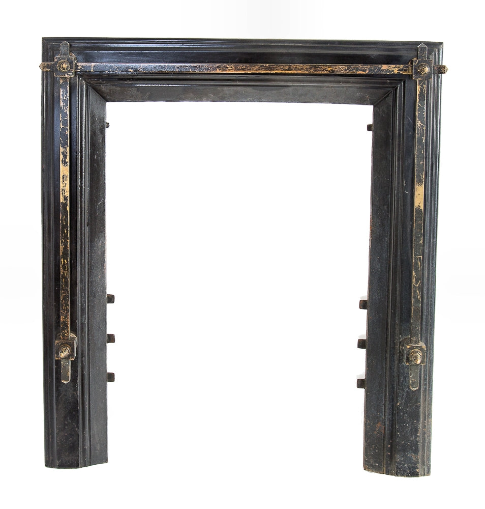 late 19th century original salvaged chicago black enameled cast iron residential fireplace surround adorned with tubular square -shaped brass rods