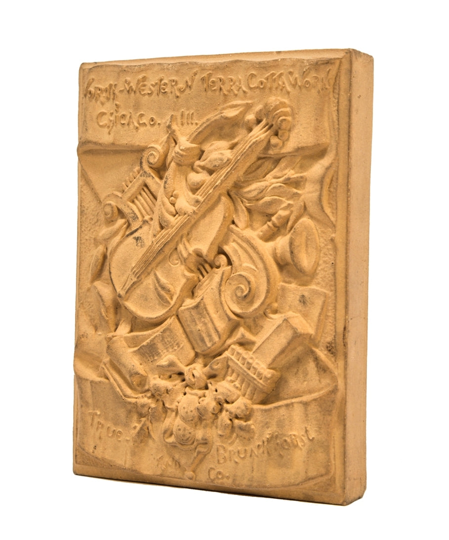 very rare early 1880's buff-colored ornamental terra cotta "salesman sample" chicago northwestern company plaque with unique assemblage of instruments