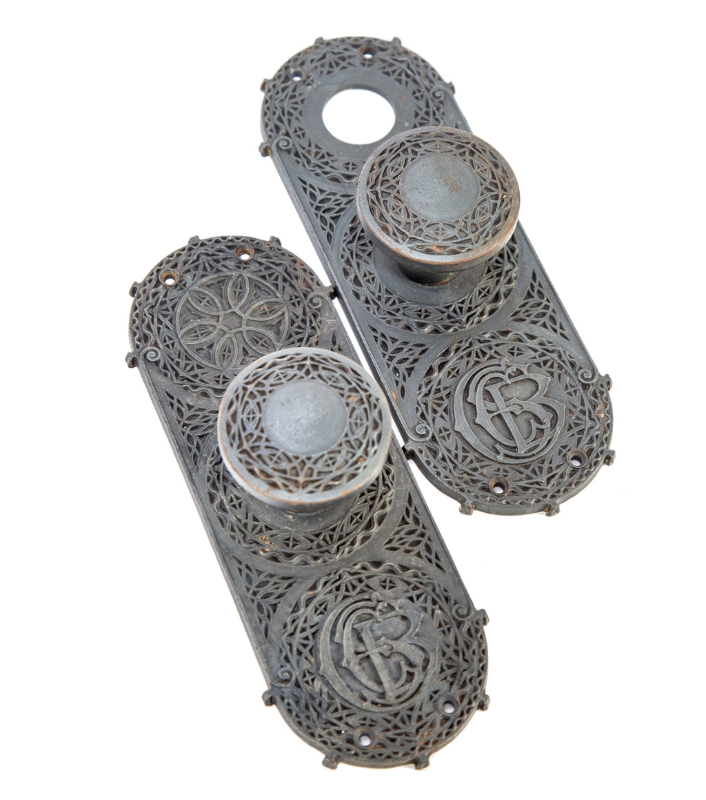 matching set of original museum-quality 1894 ornamental cast iron chicago stock exchange monogrammed backplates with matching oversized doorknobs