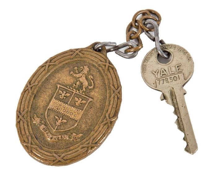 early ornamental cast brass downtown chicago stevens hotel emblematic oval-shaped key fob with rearing lion, shield, and ribbon with hotel name