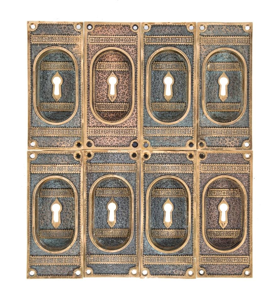 large group of hard to find and highly sought after "ivy" pattern american eastlake style cast bronze interior residential pocket door handles with nicely aged patina