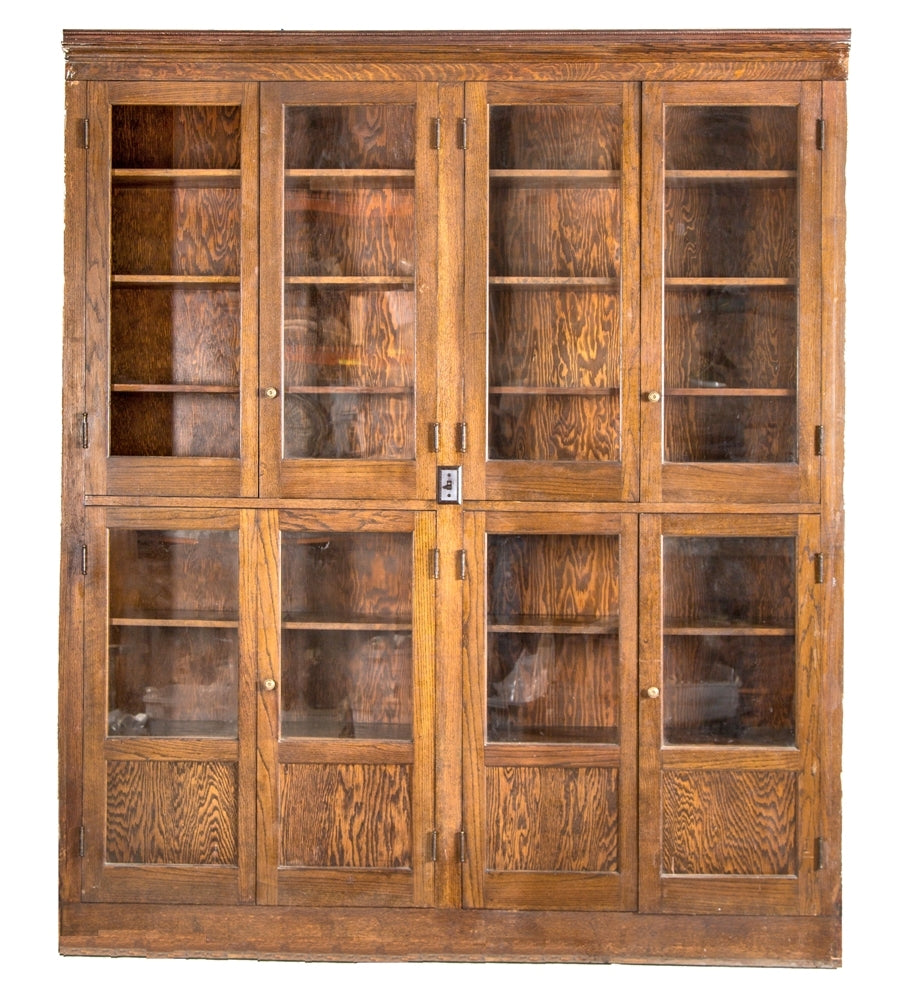 massive early 20th century two-tier varnished oak wood chicago public school laboratory display cabinet with built-in illumination and eight matching hinged doors