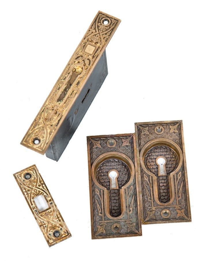 all original and intact c. 1880's antique american interior residential single pocket door hardare set with cast brass backplates, mortise lock, and catch