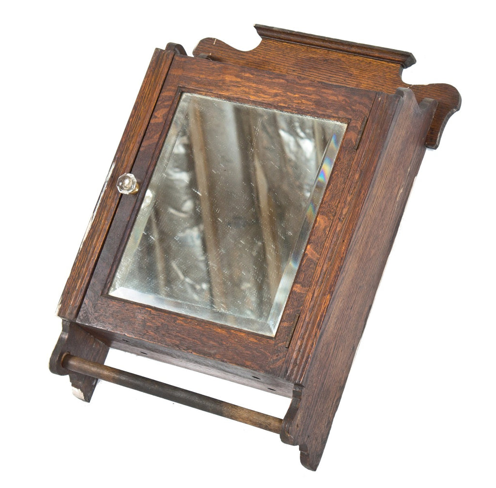 well-crafted all original early 20th century solid oak wood wall-mount interior residential lavatory or bathroom medicine cabinet with beveled mirror and towel rod
