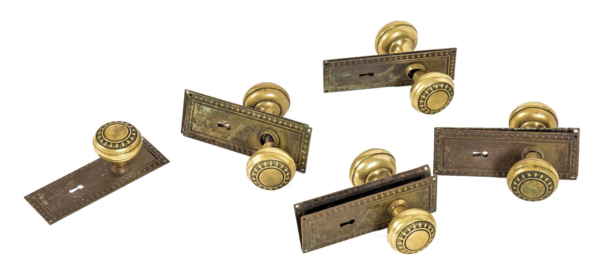 group of matching early 20th century salvaged chicago interior residential wrought brass egg and dart pattern doorknobs and backplates