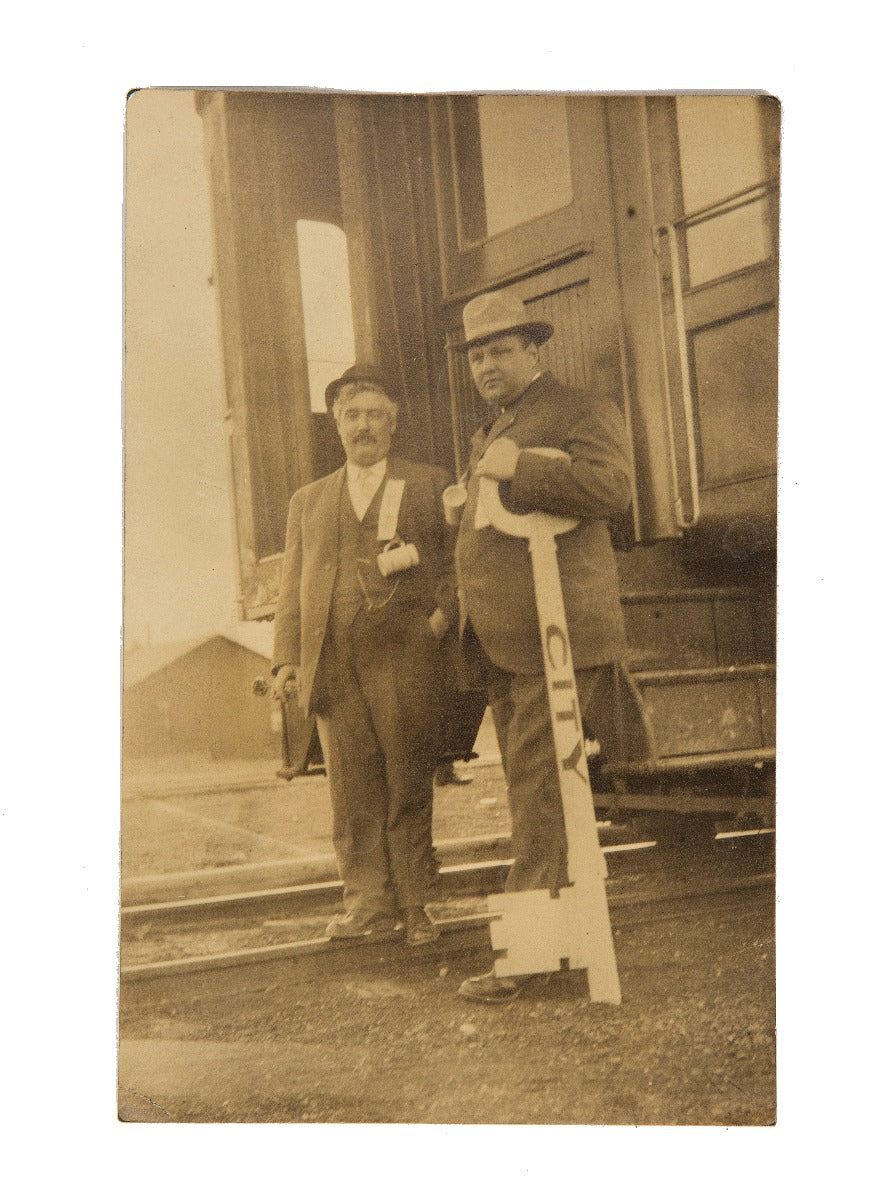 early 20th century real photo post card (rppc) of man holding oversized key to city