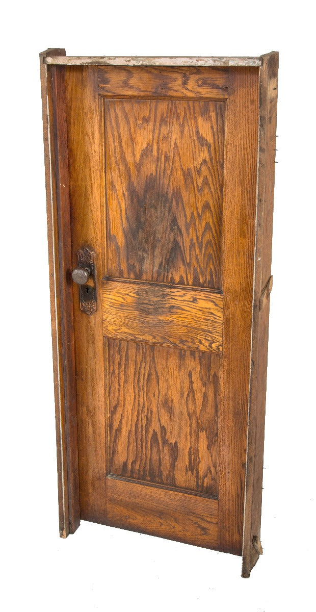 unusually small early 20th century salvaged chicago varnished oak wood paneled door with "loriane" pattern hardware and jamb