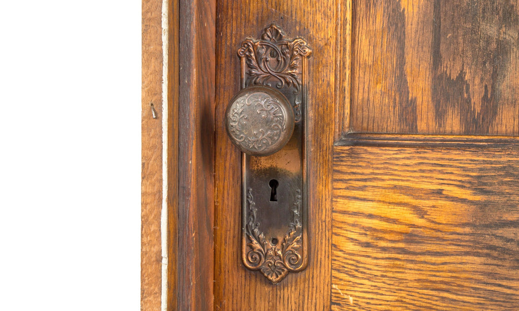 unusually small early 20th century salvaged chicago varnished oak wood paneled door with "loriane" pattern hardware and jamb