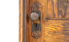 unusually small early 20th century salvaged chicago varnished oak wood paneled door with "loriane" pattern hardware and jamb